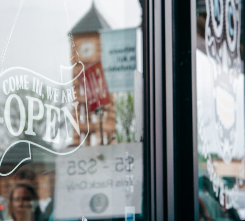 Open sign on small business in Downtown Overland Park