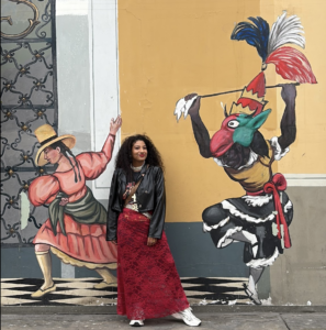 April Jay standing in front of a mural